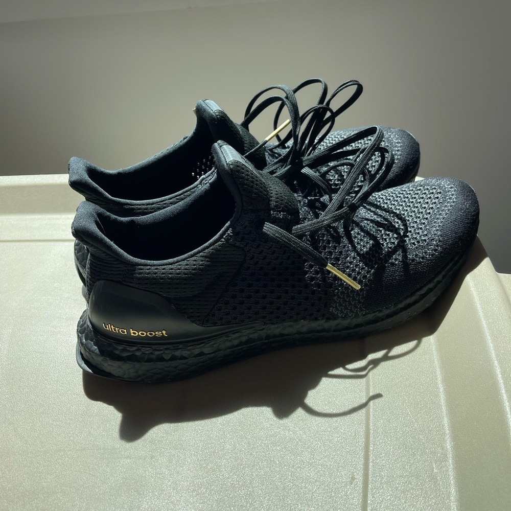 Barely worn black and gold ultra boost